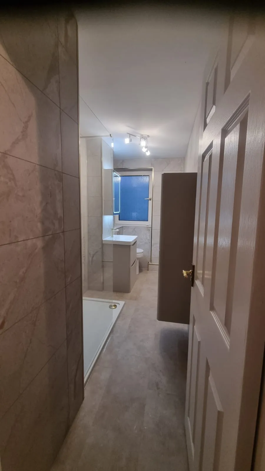 Narrow shower room with brass fittings and tall storage